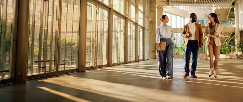 Business professionals walking together and discussing organizational priorities