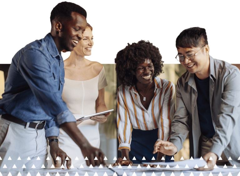 Banking professionals collaborate around a table, representing agility, compliance, and strategic growth in financial services.