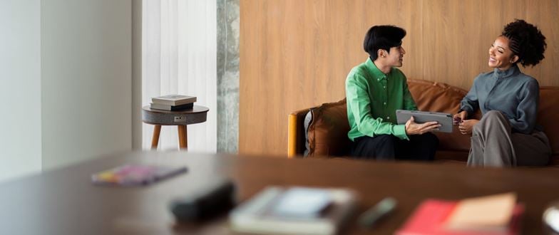 Business professionals review portfolio information together to support long-term private equity portfolio optimization.