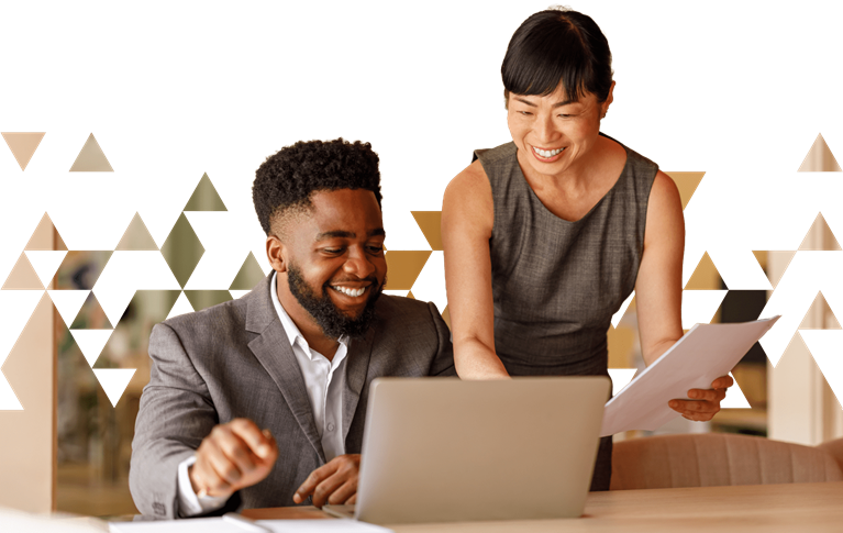 Two professionals review documents and a laptop, representing private equity deal evaluation and value creation strategy.