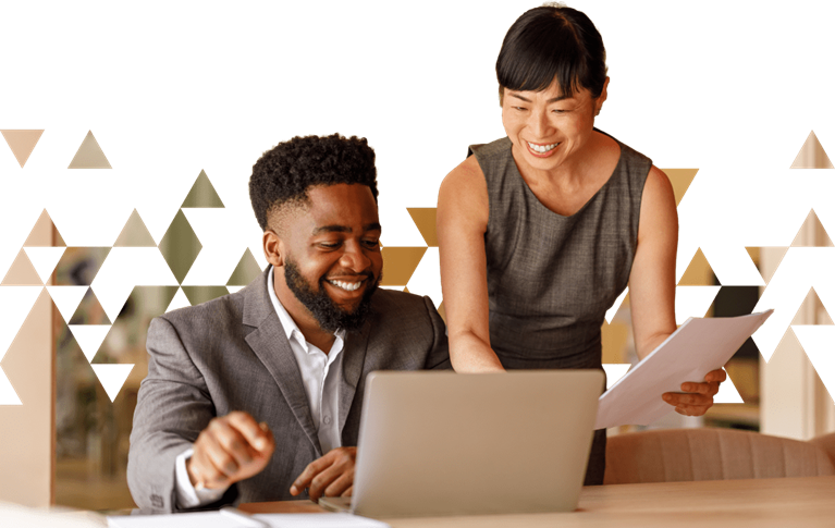 Two professionals review documents and a laptop, representing private equity deal evaluation and value creation strategy.
