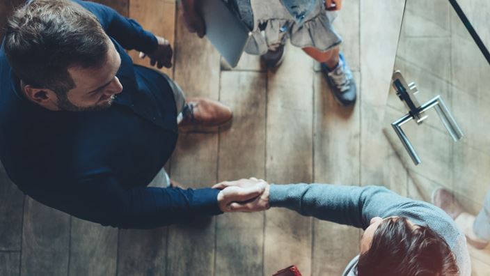  Business people shake hands as they meet discuss M&A strategy