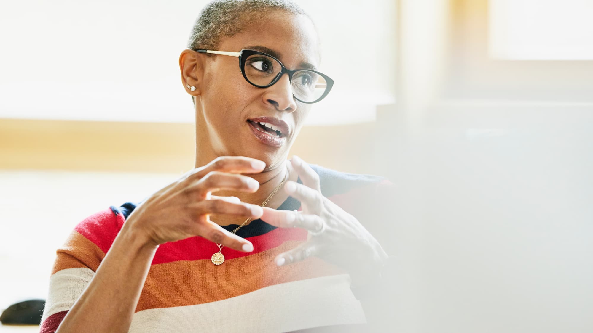 Mature African American businesswoman discussing evolving physician compensation models after M&A