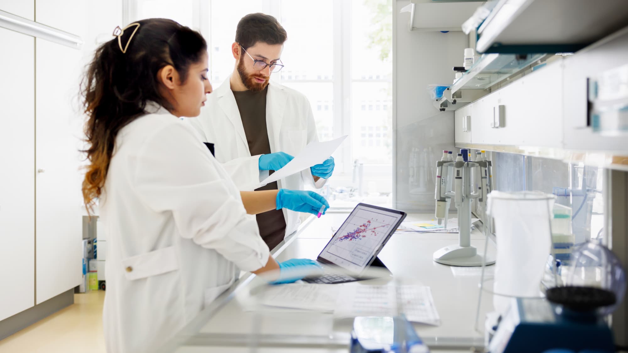 Two researchers analyze data in a lab, illustrating internal audit insight and risk awareness in the life sciences industry.