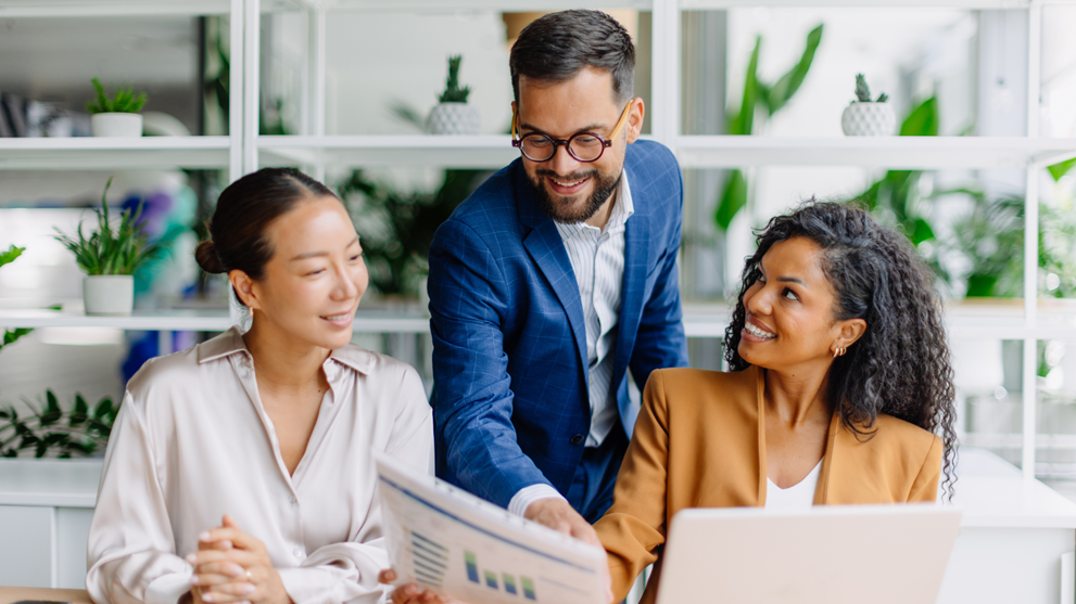 Business professionals reviewing information together on a laptop