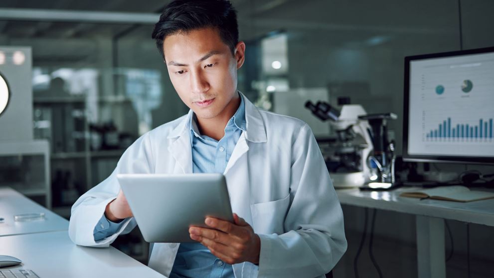 Business professional reviewing data on a tablet, representing IPO readiness assessment, risk management, governance, and organizational preparedness.