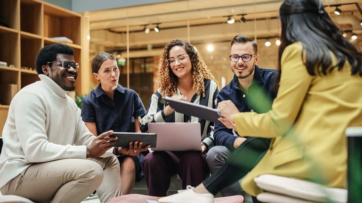 Professionals collaborate in a meeting, reflecting how cyber integration frameworks help private equity firms strengthen governance, reduce risk, and support value creation.