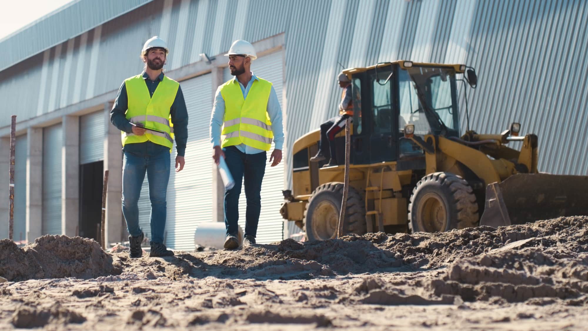 Construction team inspects a manufacturing facility project, supporting planning for QPP-eligible investments and accelerated tax deductions.