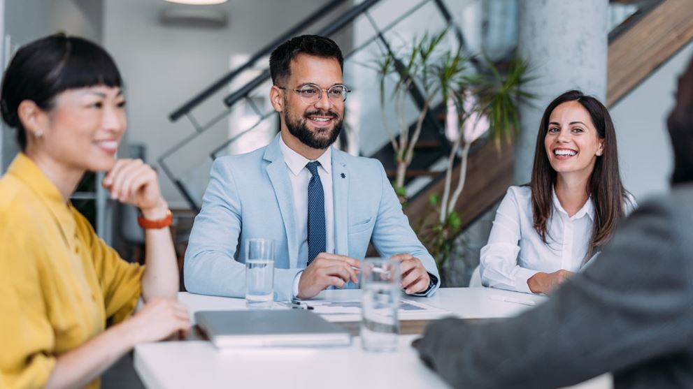 Professionals at a table discussing tax transformation