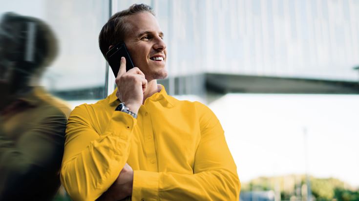 Professional speaking on a mobile phone, representing Q2 2026 accounting and financial reporting developments and updates.