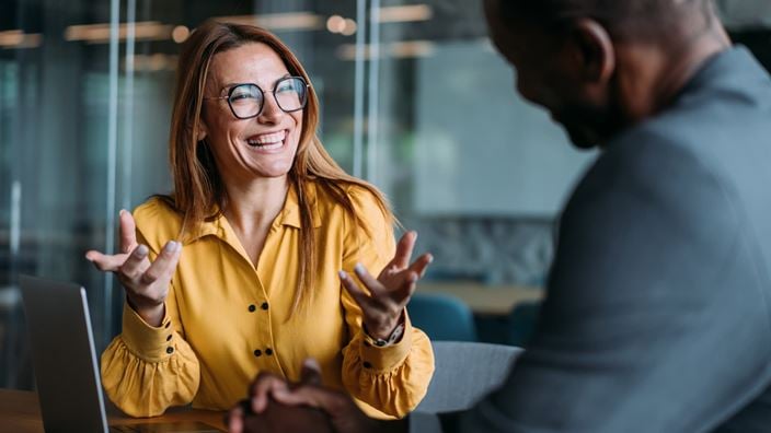 Business professionals discuss AI investment strategy and implementation in a meeting.
