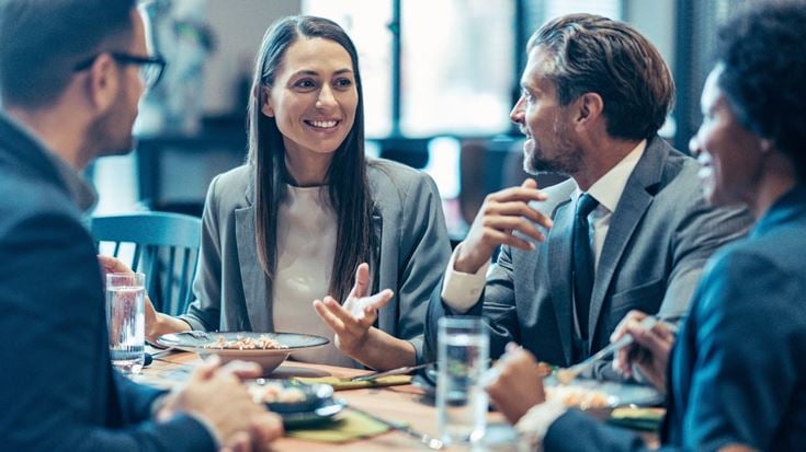 Business leaders discuss AI opportunities and strategy during a collaborative networking meeting.