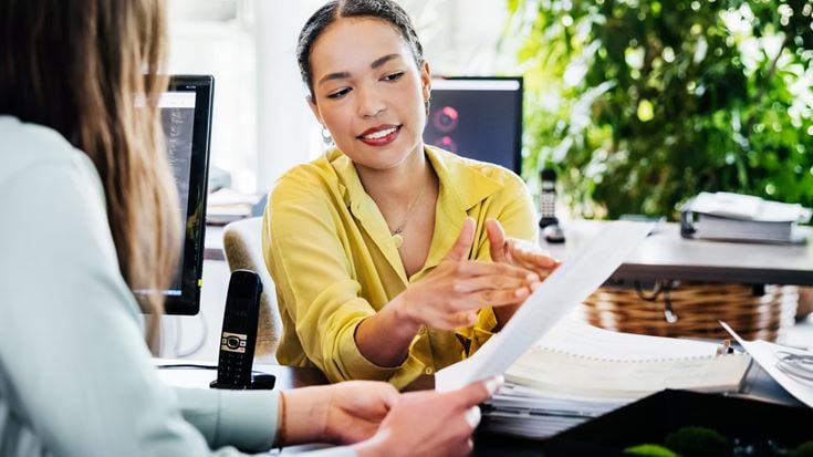Crowe specialist reviews a document while discussing three successful 2025 public sector technology modernization initiatives.
