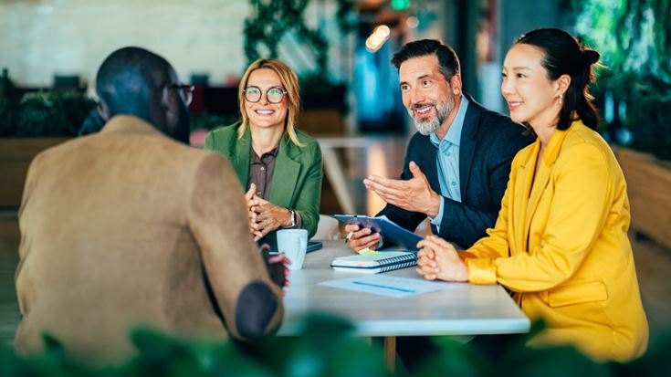 Financial professionals meeting with a client to discuss wealth management, financial planning, and investment strategies.