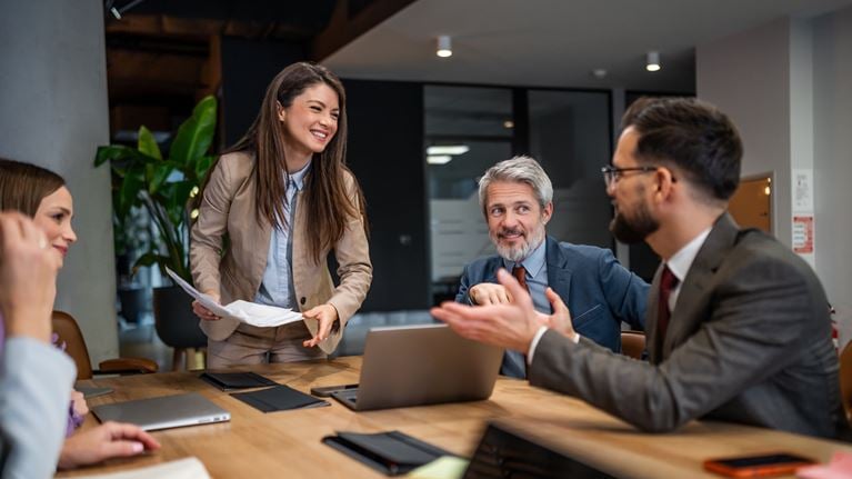 Business professionals collaborating during a corporate strategy meeting in a modern office conference room.