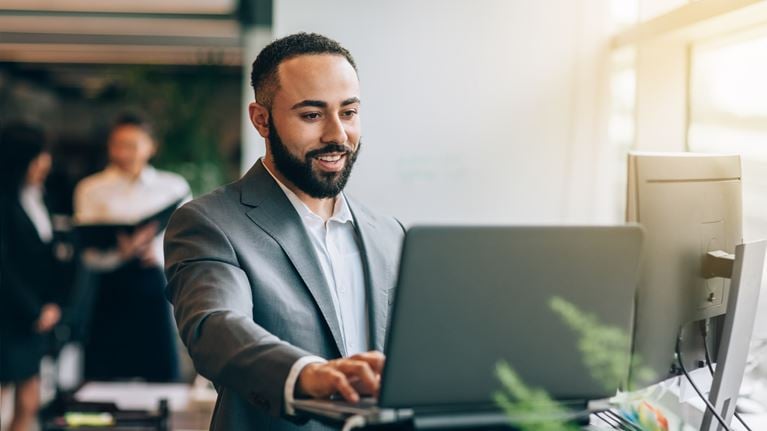 Professional using a laptop for AI-enabled financial reporting and SOX compliance work.