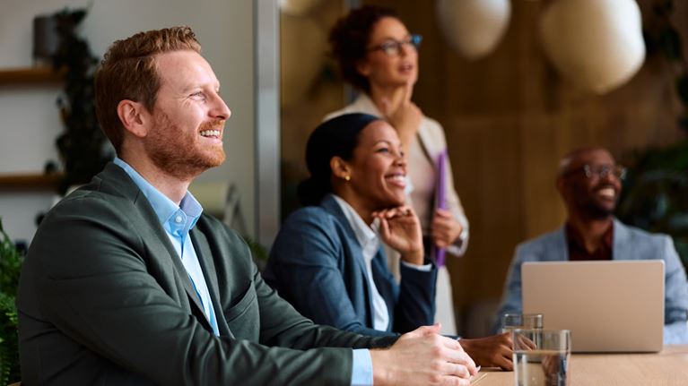 Professionals engaged in a presentation during a business meeting.