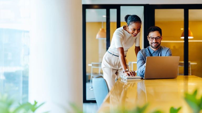 Business professionals collaborate on AI solutions and technology investments.