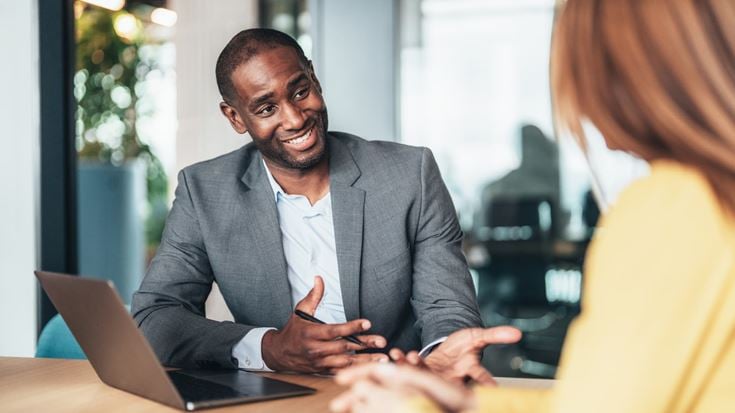 Professionals discussing data governance and collaboration in an office.