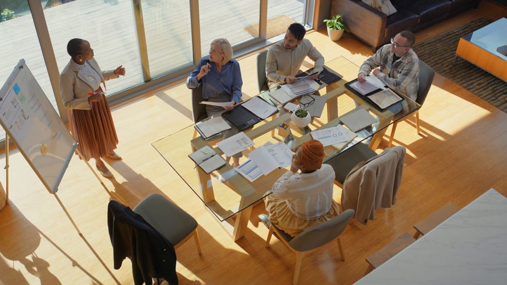Alt Text: “Financial professionals discuss regulatory and accounting developments during a team meeting.