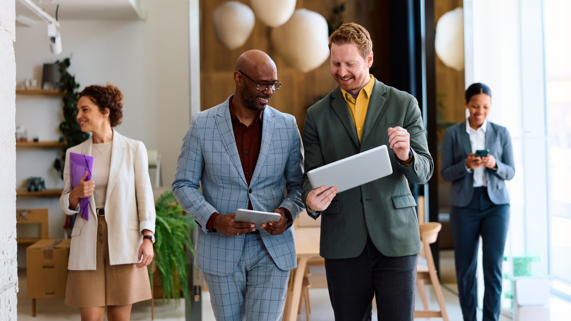 Banking professionals review regulatory updates and financial reporting guidance using digital tools.