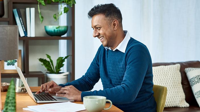 A professional reviews ERP system options on a laptop.