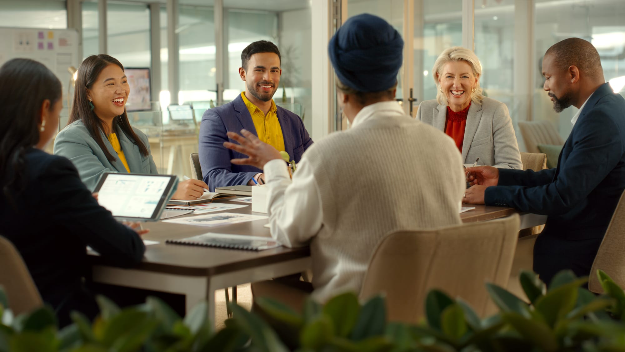 Business professionals meet to discuss growth opportunities, representing expanded capital access and reporting flexibility.
