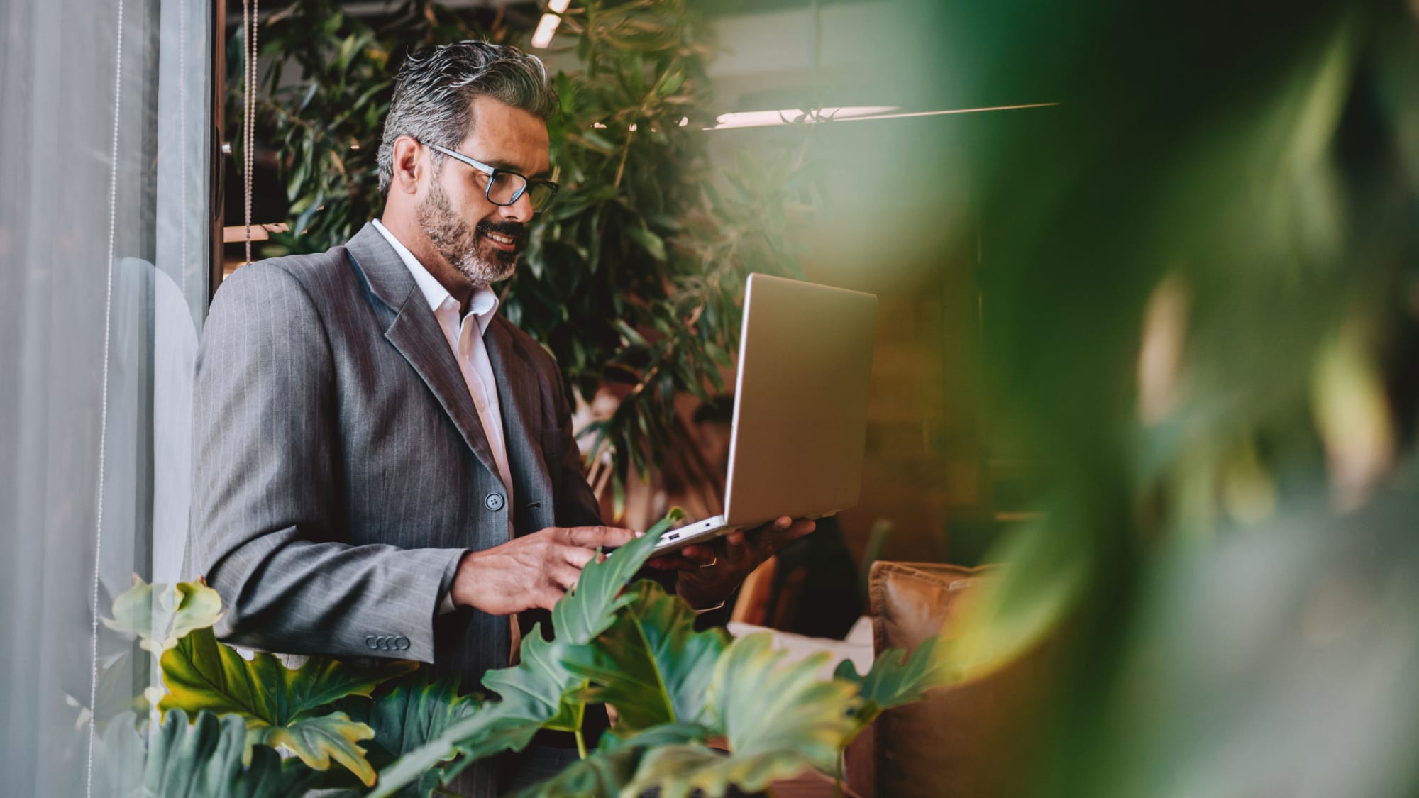 Professional reviews environmental credit accounting guidance on a laptop.
