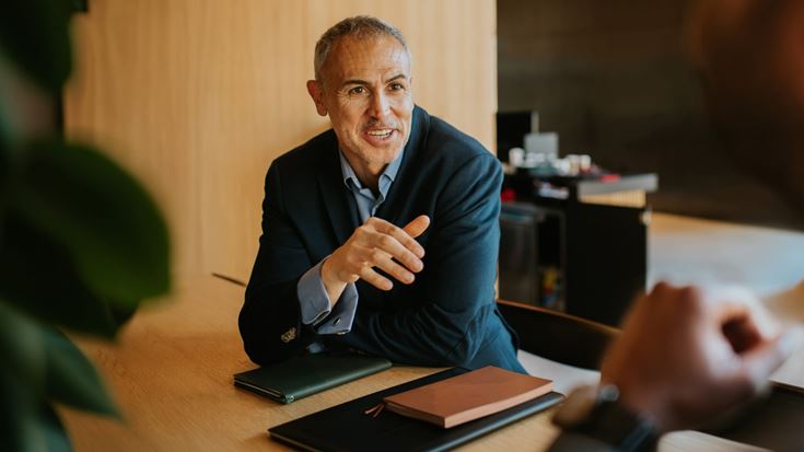 Financial professional discusses accounting and reporting considerations during a meeting.