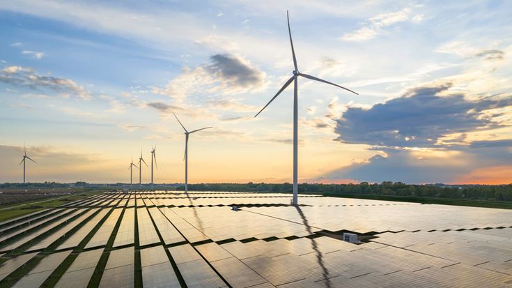 Wind turbines and solar panels illustrate renewable energy projects affected by the restored 5% safe harbor for beginning-of-construction deadlines.