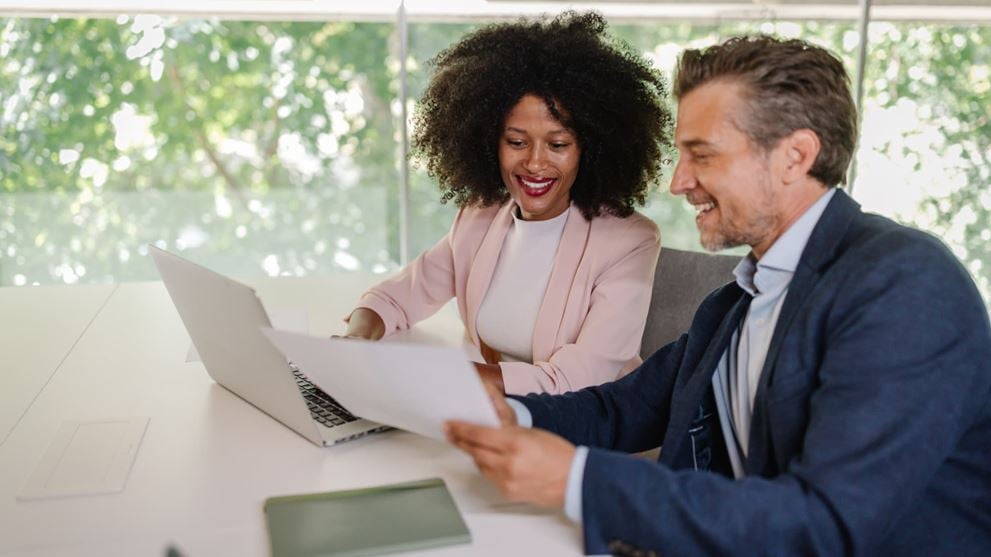 Professionals reviewing documents together during a business meeting