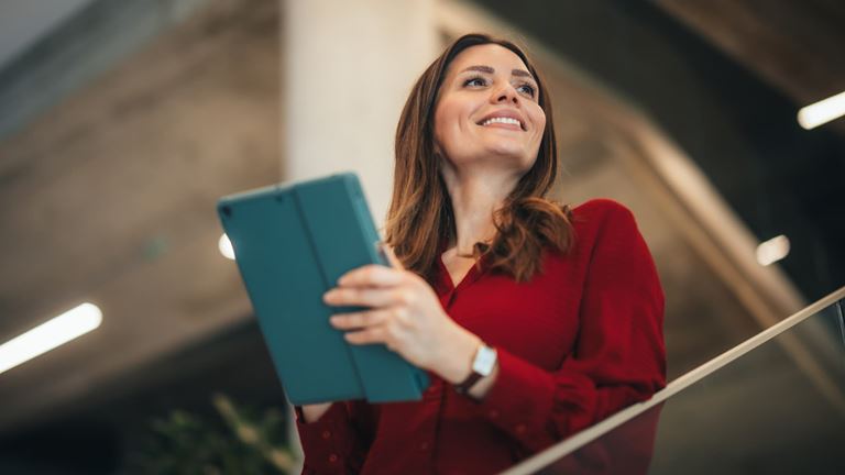 Business professional uses a tablet to support risk management planning.