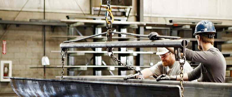 Steel service center workers handling metal materials