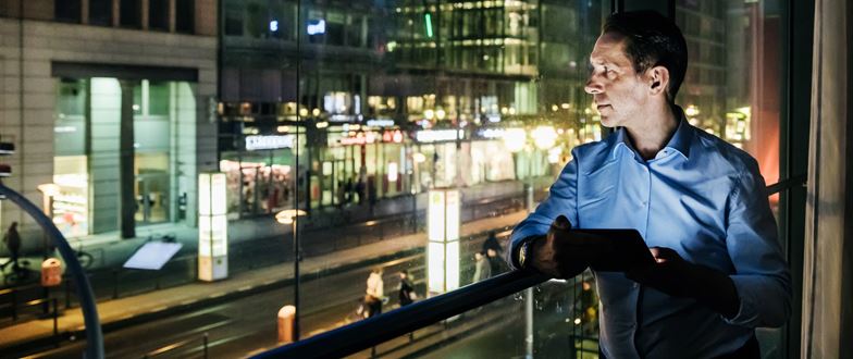Banking professional uses digital technology to support customer relationship management.