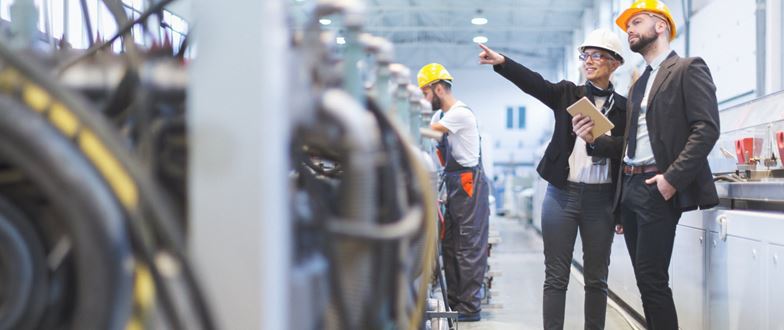 Manufacturing team reviews operations and systems, supporting integrated production and ERP-driven efficiency.