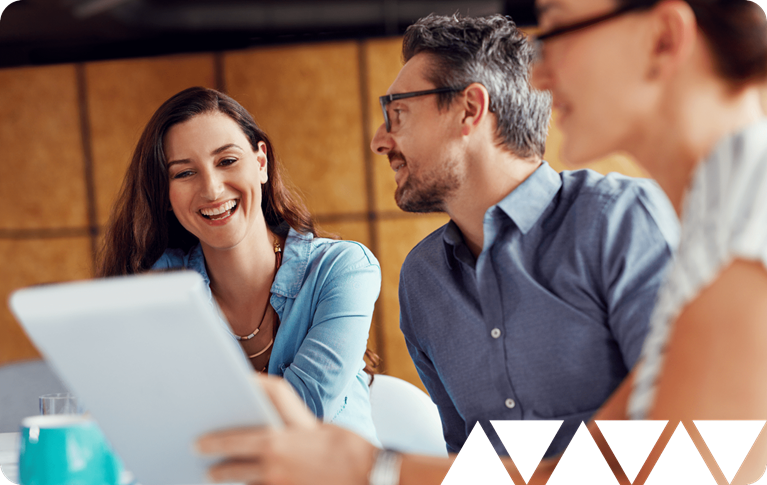Financial services professionals collaborate around a tablet, representing strategic planning for crypto and digital assets.