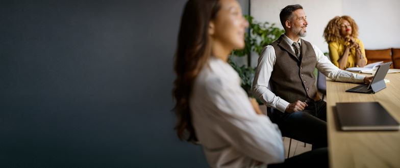 Professionals discuss indirect tax compliance and reporting during a business meeting.