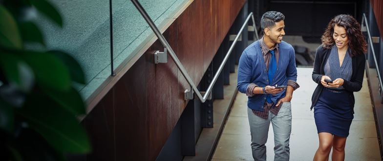 Two professionals walking together and discussing work