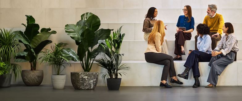 Professionals discussing international business strategy in a collaborative workplace setting.
