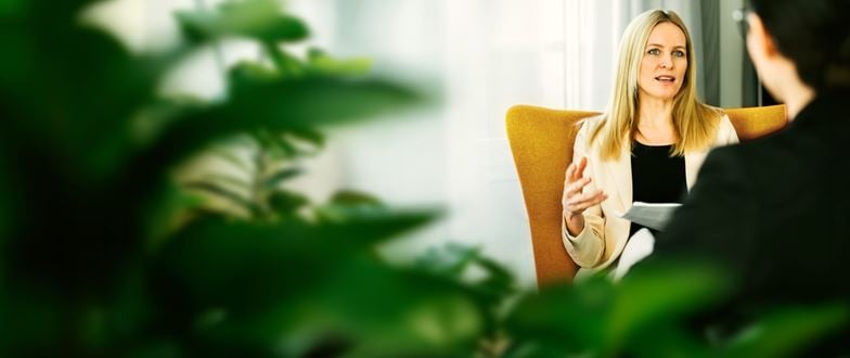 Professional consults with a client, representing guidance on unclaimed property compliance and reporting needs.