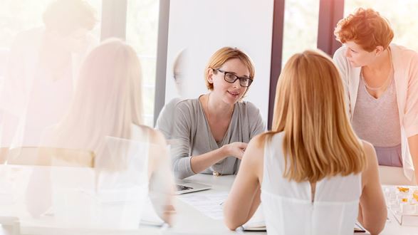 Group of women in a corporate office having a discussion