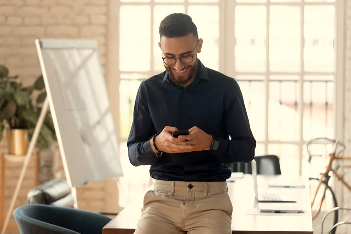Man_Looking_at_Phone_Smiling