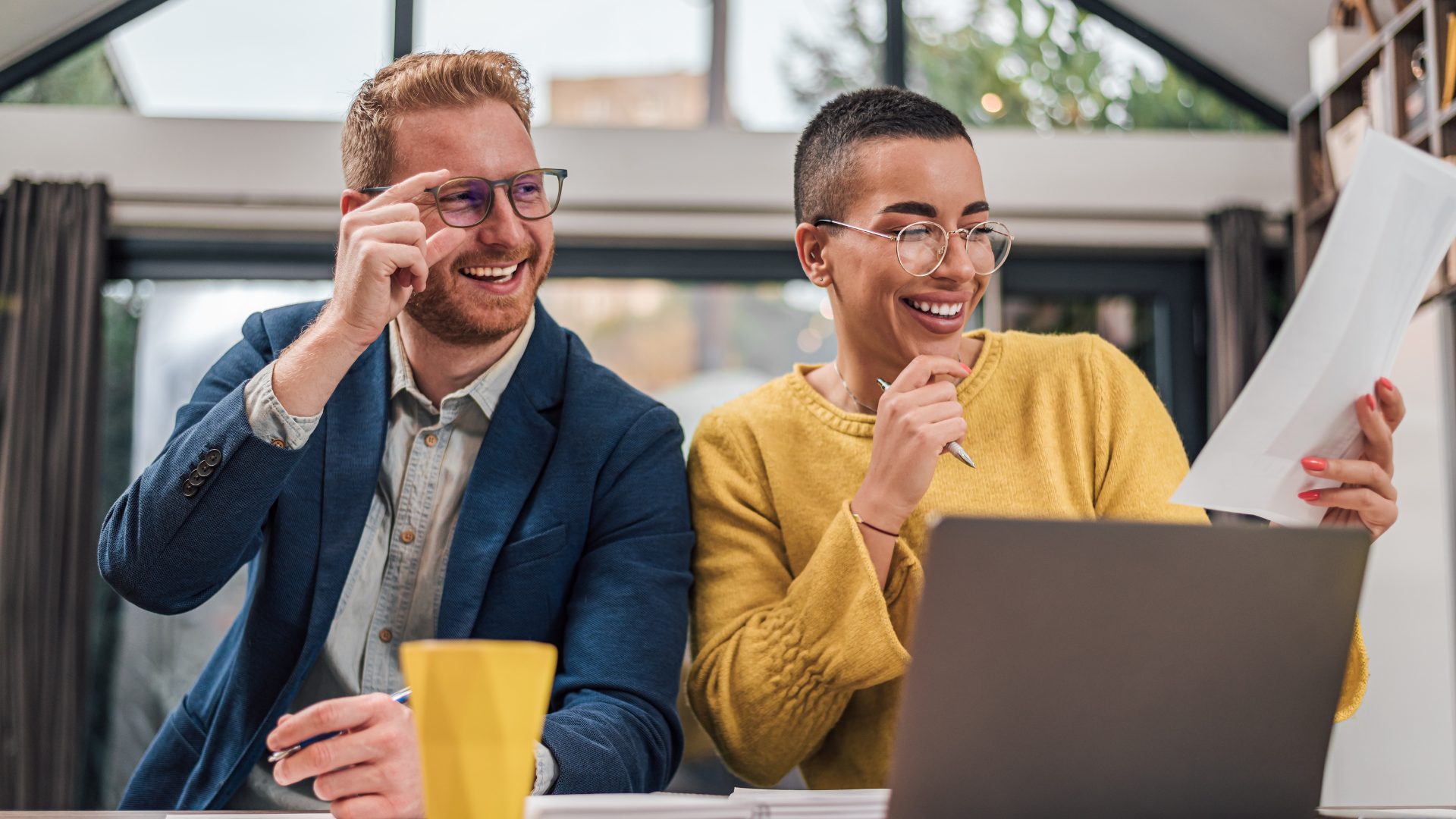 People Smiling Looking at Document