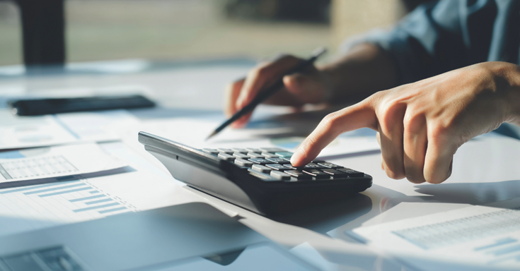 person working on a calculator