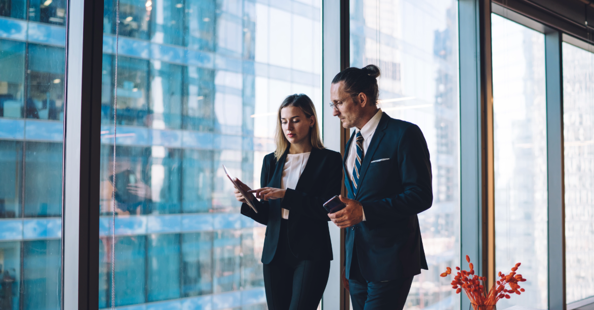 two people walking through the office