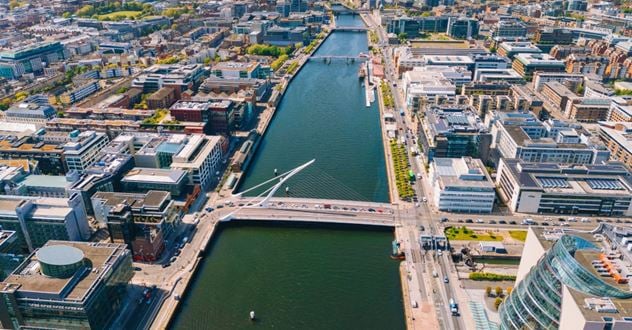 An aerial view of the River Liffey with the Samuel Beckett Bridge in the foreground