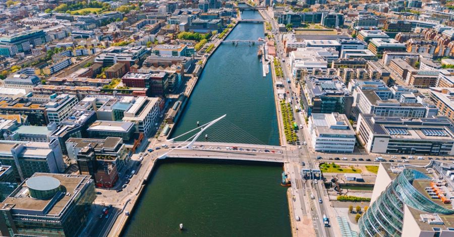 An aerial view of the River Liffey with the Samuel Beckett Bridge in the foreground