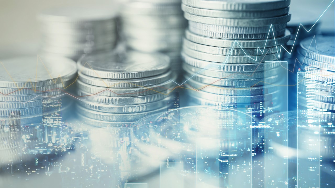 Stacks of coins with bar and line chart overlays