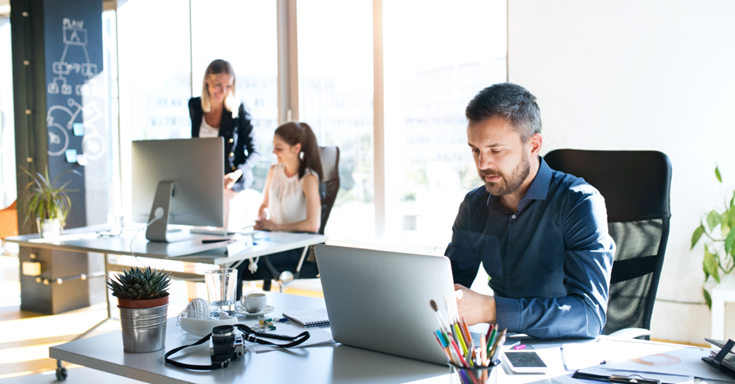 People in an office working at computers