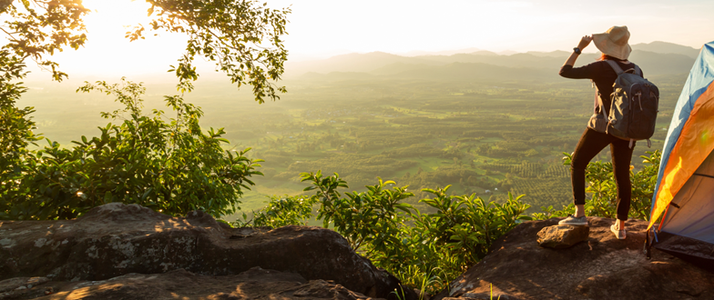 A woman looking out over sunny fields